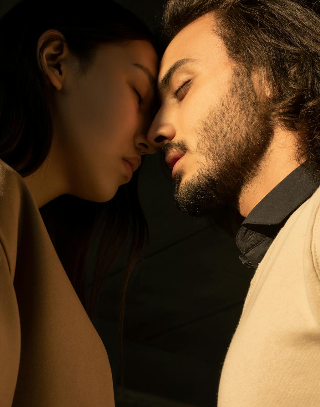 man and woman closing their eyes