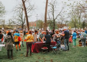 People gather outdoors, possibly at an event.
