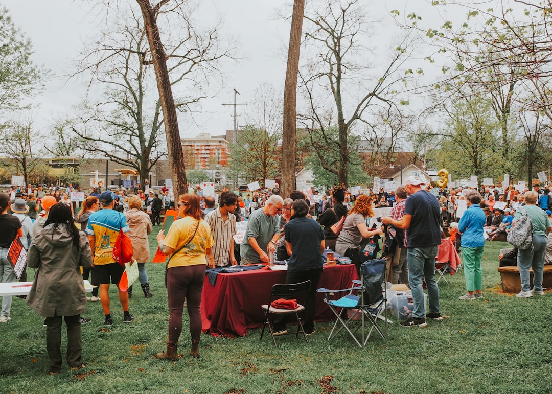 People gather outdoors, possibly at an event.