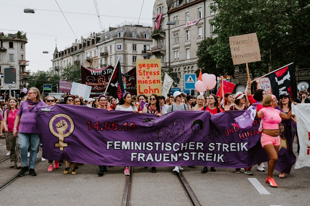 group of people holding purple banner
