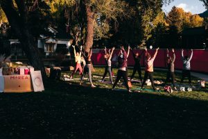 a group of people doing yoga in a park