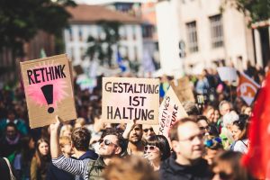 shallow focus photo of person holding signage