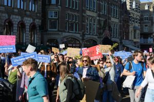 Crowd of people holding signs at a protest