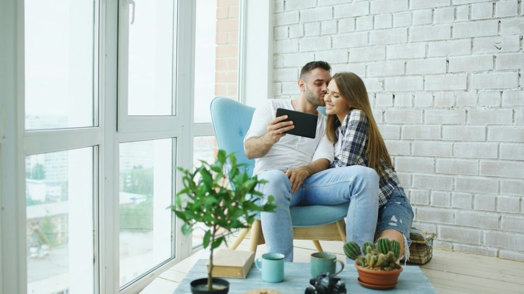 Couple looking at tablet in a bright room