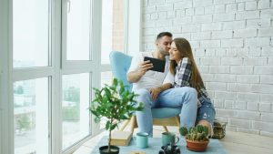 Couple looking at tablet in a bright room