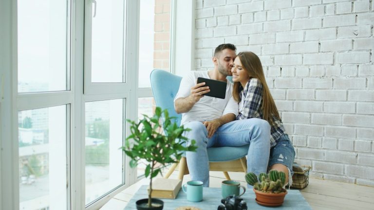 Couple looking at tablet in a bright room