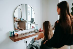 A woman gets her hair styled at a salon